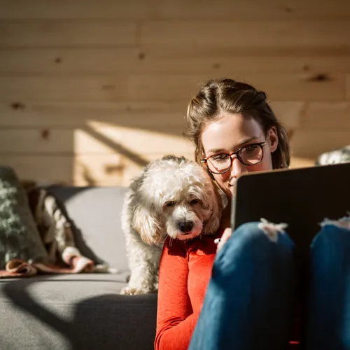 Woman and her dog watching her tablet